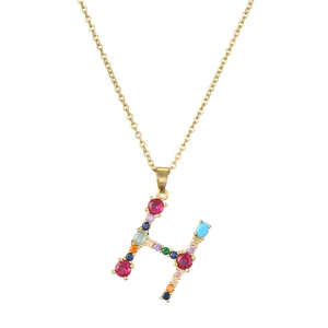 Close-up of letter H pendant with rainbow colored gemstones and gold plated chain