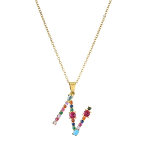 Close-up of golden letter N necklace pendant with colorful inlaid gemstones detail