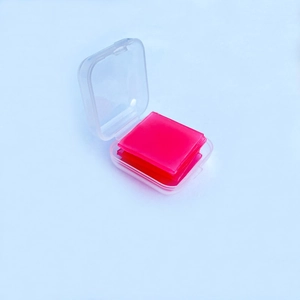 Close-up of pink diamond painting wax pads in a clear plastic storage box