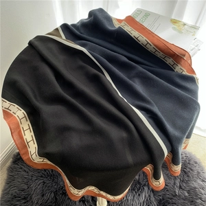 Close-up of soft linen cotton scarf featuring elegant color-block H pattern design