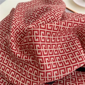 Detail of red and beige square patterned cotton scarf with soft woven texture