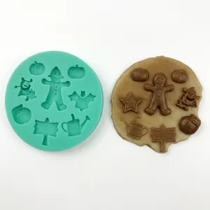 Macro detail of silicone mold with pumpkin, ghost, and tree shapes for Halloween baking