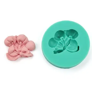 Detail of DIY olive leaf silicone mold and pink floral fondant craft on white background