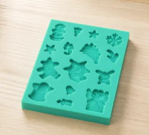 Detailed top view of green silicone mold with 5 snowman and star cavities for fondant