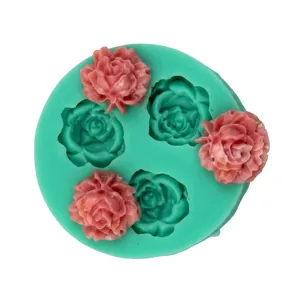 Detail of green silicone mold with rose flower cavities and pink fondant samples