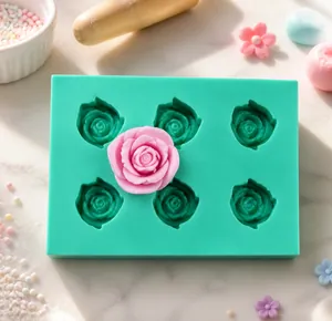 Detail view of 6-cavity green silicone cake mold featuring delicate rose flower patterns