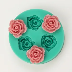 Detail of pink fondant roses showing high precision mold results on green silicone tray