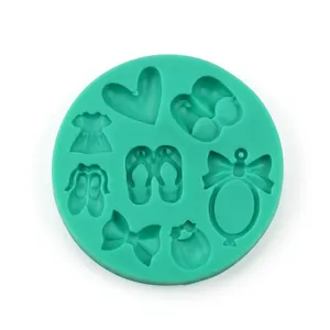 Green silicone mold with hearts, shoes, bows, and baby bottle shapes for DIY baking