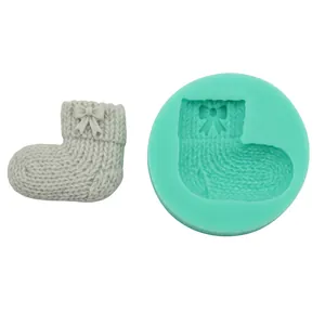 Detailed view of mint green silicone sock mold with textured knit patterns
