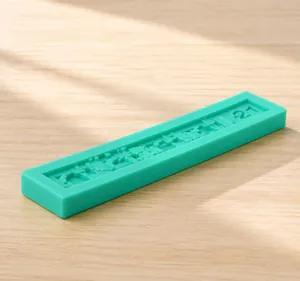 Detailed macro view of the rectangular green silicone mold with repeating number 21 pattern