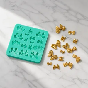 Detail of mint green silicone mold with butterfly shapes and golden resin crafts