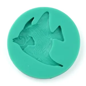 Detail view of a green silicone mold featuring a tropical fish shape for fondant and DIY crafts