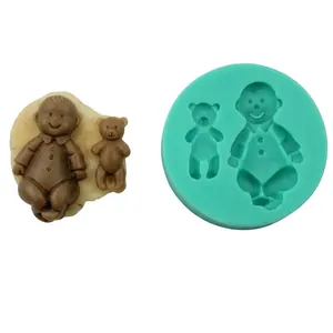 Detail of round green silicone mold featuring baby and small bear shapes for cake baking
