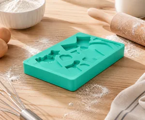Detail of green silicone mold featuring fruit shapes for fondant and chocolate baking