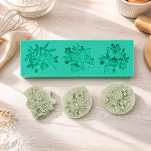 Close-up of green silicone rose flower mold with white fondant floral decorations