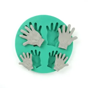 Detailed view of mint green silicone mold with four hand-shaped cavities for DIY soap making
