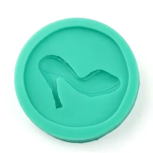 Detail of round green silicone mold featuring a high heel shoe cavity for fondant baking