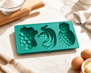 Detailed macro view of green silicone mold featuring pineapple, banana, and peach cavities