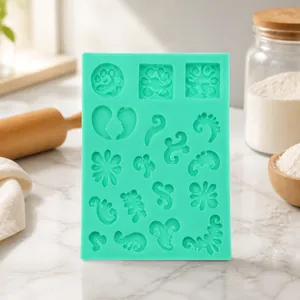 Detailed blue silicone mold with intricate vintage scroll and vine patterns for fondant