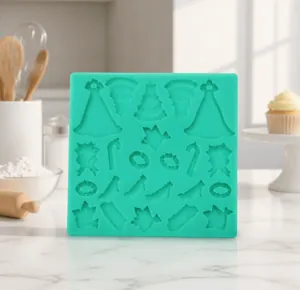 Detailed teal silicone mold featuring dress, high heels, and bird patterns for DIY baking