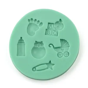Macro detail of a green silicone fondant mold featuring baby bottle and stroller patterns