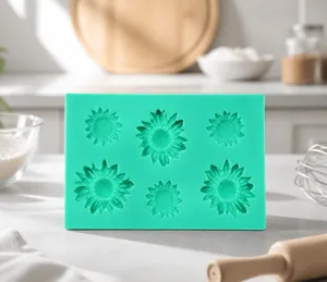 Detail view of a green silicone mold featuring six different sunflower patterns for baking