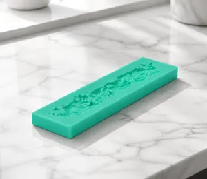 Macro detail of mint green silicone fondant mold with intricate floral relief pattern