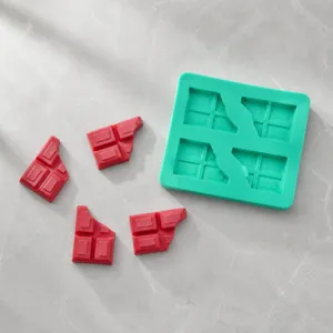 Detail of green silicone mold with four compartments and textured chocolate squares