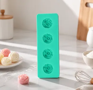 Detail view of a 4-cavity green silicone mold with intricate 3D rose flower shapes