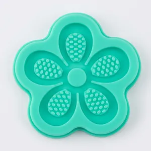 Macro view of green silicone flower mold showing intricate textured details and patterns
