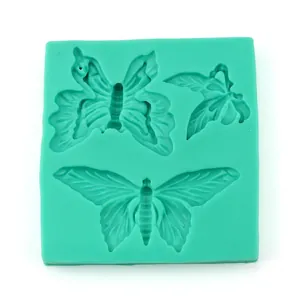 Detail of green silicone lace mold featuring three different butterfly fondant patterns