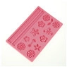 Macro detail of pink silicone cake mold featuring floral and leaf patterns for DIY baking