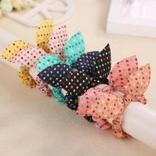 Detail of colorful bunny ear hair ties with heart patterns on a white display stand