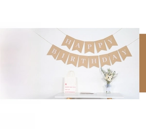 Close-up of vintage kraft paper Happy Birthday bunting with white letters for party decor