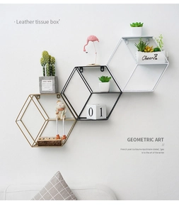 Three geometric hexagonal wall shelves in gold, black, and white metal wire frames
