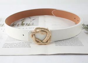 Detail of a white leather belt with a golden snake-shaped buckle on an open magazine