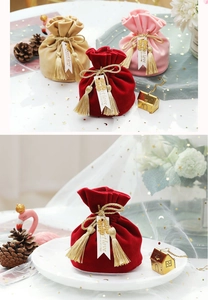 Detailed close-up of velvet wedding favor bags with gold tassels and sweet love tags