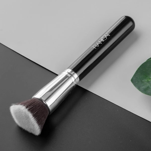 Detailed close-up of a flat top foundation brush with soft synthetic bristles and black handle
