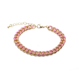 Detail of pink and gold Cuban chain bracelet with enamel finish and lobster clasp