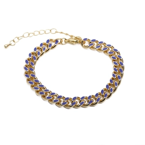 Detail of gold Cuban chain bracelet with blue enamel inlay and lobster clasp