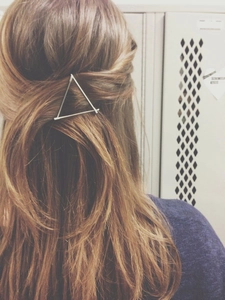 Minimalist alloy triangle hair clip worn on brown hair showing secure and elegant hold