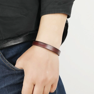 Minimalist dark brown leather bracelet with magnetic clasp on wrist for men and women