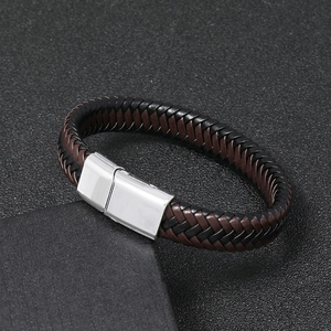 Dettaglio di un bracciale in pelle intrecciata con chiusura magnetica in metallo