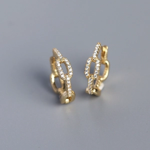 Detailed macro view of S925 silver link earrings with gold plating and cubic zirconia