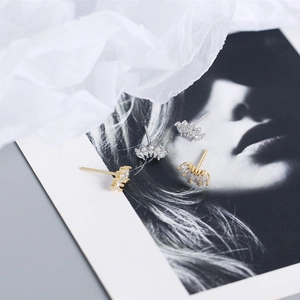Detailed view of gold and silver marquise zircon fan-shaped stud earrings on portrait card