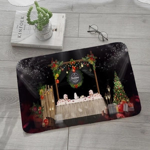 Top view of festive Merry Christmas flannel mat with a non-slip base on grey wood flooring