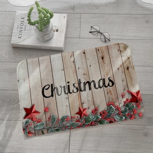 Detailed view of rectangular Christmas doormat with wood grain pattern and holly leaves