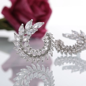 Detailed view of silver leaf wreath earrings with sparkling marquise cut cubic zirconia