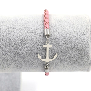 Detail of pink braided leather bracelet with silver anchor charm and metal clasp