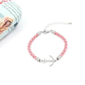 Close-up of pink woven leather bracelet with silver anchor pendant and adjustable chain